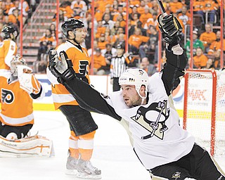 The Pittsburgh Penguins’ Steve Sullivan celebrates after scoring a goal against the Philadelphia Flyers’ Kimmo
Timonen, center, and goalie Sergei Bobrovsky during the second period of Game 4 of the Eastern Conference quarterfinals of the NHL Stanley Cup playoff s Wednesday at Wells Fargo Center in Philadelphia. On the verge of a sweep, the Penguins rallied with a vengeance to defeat the Flyers, 10-3, and avoid elimination. The series move back to Pittsburgh for Game 5 on Friday.