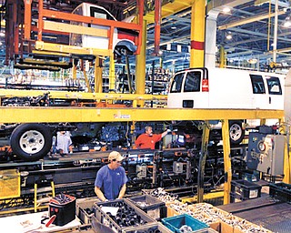 General Motors employees work on a van assembly line at GM’s plant in Wentzville, Mo. The U.S. auto industry, already stretched to meet growing car and truck sales, faces parts shortages that could limit the number of new vehicles in showrooms later this year and crimp a historic turnaround.