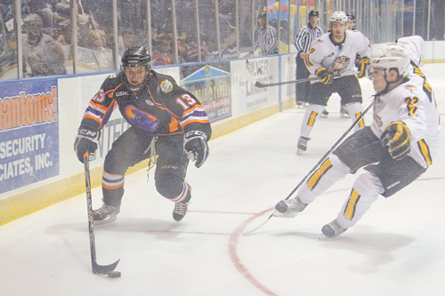 Phantoms’ Ryan Lowney (13) tries to keep control of the puck while being defended by the Gamblers’ Dakota Mermis during the first period of the second-round USHL playoff game Tuesday at the Covelli Centre in Youngstown.