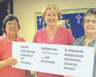 The Women’s Altar and Rosary Guild of St. Thomas the Apostle Church (formerly St. Vincent de Paul), 4453 Warren-Sharon Road, Vienna, will sponsor its annual rummage sale from 10 a.m. to 4 p.m. May 4 and from 9 a.m. to 2 p.m. May 5. Holding a banner listing the details are, from left, Florence Gordon, treasurer; Pat Slavin, project chairwoman and secretary; and Dianne Setterberg, guild co-president. The sale will include household and kitchen items, linens, crafts, children’s clothes, small furniture, jewelry, books and more. There will be free admission and parking, and Saturday will be half-price day.