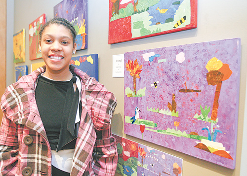 Chaney sixth-grader Beunita Jones stands by several images she helped create for the book “A Walk In the Garden” based on experiences of 40 students who spent time in Mill Creek Park.