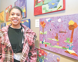Chaney sixth-grader Beunita Jones stands by several images she helped create for the book “A Walk In the Garden” based on experiences of 40 students who spent time in Mill Creek Park.