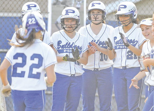 Poland’s Erin Gabriel is greeted by teammates, including Marissa Trevis (12), Arlia Duarte (10) and Kalie Benson (21), as she heads home after hitting a grand slam in the fourth inning of Wednesday’s softball game against Howland in Poland. As the starting pitcher, Gabriel posted 13 strikeouts and allowed only two hits in the Bulldogs’ 17-2 win over the Tigers.