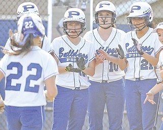 Poland’s Erin Gabriel is greeted by teammates, including Marissa Trevis (12), Arlia Duarte (10) and Kalie Benson (21), as she heads home after hitting a grand slam in the fourth inning of Wednesday’s softball game against Howland in Poland. As the starting pitcher, Gabriel posted 13 strikeouts and allowed only two hits in the Bulldogs’ 17-2 win over the Tigers.