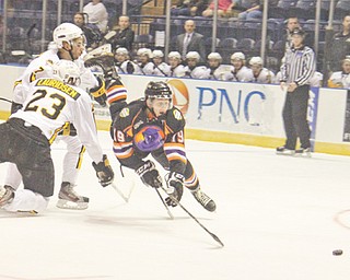 The Youngstown Phantoms’ Dylan Margonari (19) is tripped up by the Green Bay Gamblers’ Markus Lauridsen (23) during the fi rst period of Game 4 of Eastern Conference semifi nals of the USHL’s Clark Cup playoffs Wednesday at the Covelli Centre. The Phantoms led 1-0 after two periods, but the Gamblers rallied to win 4-1,
bringing Youngstown’s season to an end.
