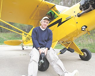 Gordon Murray, a Girard native, is shown with his vintage Piper Cub plane he will fly to each of Ohio’s 88 counties beginning May 13. Murray and Ron Siwik of Chagrin Falls, who will fly another vintage plane, are making the trip to raise funds to establish a scholarship for a needy Ohio family to send a child to college. The team expects to land at Youngstown Elser Metro Airport in North Lima on May 15.