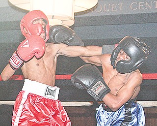 Terrance Holloway (red) from Farrell and Jamir Fudge of Warren Harding battle during their flyweight battle Monday night in the finals of the K.O. Drugs High School boxing tournament. Holloway won the championship with an unanimous decision in the event at St. Lucy Palermo Banquet Center in Campbell.