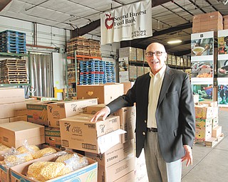Michael Iberis, executive director of Second Harvest Food Bank of the Mahoning Valley, flashes a million-dollar smile as he stands in the food bank’s warehouse at 2805 Salt Springs Road, Youngstown.