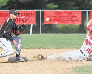 James Tate of Niles steals second base ahead of the throw to Canfield’s Joe Tuchek during Thursday’s baseball game in Canfield. The Red Dragons edged the Cardinals, 7-6, to clinch a share of the All-American Conference American Division championship.