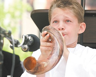 Elijah Maybou, 9, of Warren blows a shofar (ram’s horn) to begin the noon National Day of Prayer observance
in downtown Youngstown. The event, sponsored by the City Prayer Team of Youngstown, featured Pastor Everett Whiteside as keynote speaker.