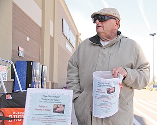 Charlie Granger of Austintown holds a bucket in front of the Walmart in Austintown for donations to Zion Luthern Church to help feed the needy.
