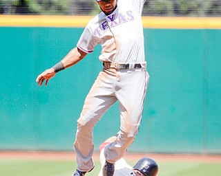 Texas Rangers shortstop Elvis Andrus leaps high to snag a throw from catcher Yorvit Torrealba as Cleveland Indians’ Shin-Soo Choo steals second in the second inning of a game in Cleveland on Sunday.