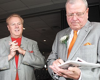 Cleveland sports personality Bruce Drennan, right, signs an autograph for Frank Frattaroli of Struthers during the
Curbstone Coaches Hall of Fame Banquet on Sunday at Mr. Anthony’s in Boardman.