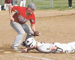 Liberty’s Tyler Evans (18) slides under the tag of LaBrae’s Bobby Klein during a Division III sectional tournament baseball game Monday in Liberty. The Leopards defeated the Vikings, 4-2, to advance to today’s round against Girard.