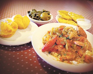 Monteen’s Southern Cuisine’s signature Jambalaya dish served on a bed of rice topped with andouille sausage, fresh tomatoes, okra, celery, peppers and crawfish. Served with a side of breaded fried green tomatoes and collard greens.