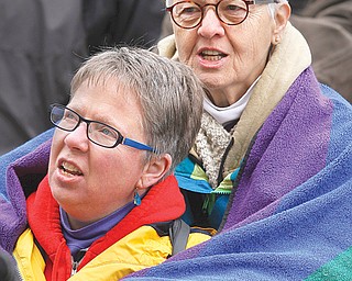 Glorianne Leck of Bloomington, Ind., wraps a blanket around her partner, Susan Savastuk, during a March 2011 rally at the Indiana Statehouse. Leck and Savastuk had a commitment ceremony in Youngstown in 1995 and support same-sex marriage.