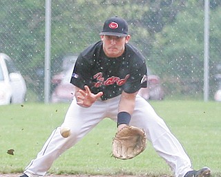 Girard’s Dan Graziano fields a ground ball — and a little mud — to make a play at first base during a Division III tournament baseball game Wednesday against the Liberty Leopards in Girard. The teams were tied 1-1 through the bottom of the seventh inning, then Girard’s A.J. Devore hit a sacrifice fly in the bottom of the 11th to score Tyler Alejars and give the Indians the 2-1 win.