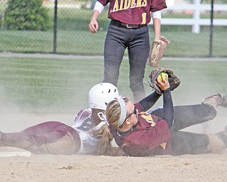 Stevie Taylor of South Range shows the ball to the umpire after she tagged out Liberty baserunner Allyson
Solarz during a Division III sectional softball game Thursday in Beaver Township. The Raiders blanked the
Leopards, 10-0.