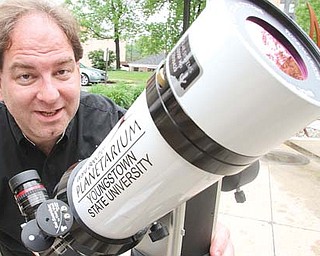 YSU Astronomy professor Dr. Patrick Durrell shows a telescope that will be used for viewing the June 5 transit of Venus.