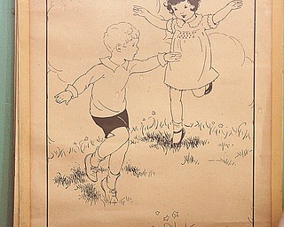 A poster-sized reading aid hangs on the wall — akin to the Dick and Jane series used to teach reading.