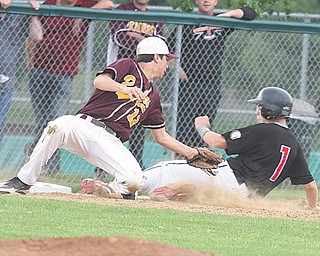 Jim Standohar (1) of Girard slides in behind the tag of South Range’s Mason Miller (12) during their Division III district semifinal baseball game Monday at Cene Park in Struthers. The Indians blanked the Raiders, 10-0, and advance to play Ursuline in the district championship today.