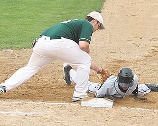 Crestview’s Austin Eskra (10) scrambles back to the bag as Ursuline’s Sam Donko (13) applies the tag during
a Division III district semifinal baseball game Monday at Cene Park in Struthers. The Irish downed the Rebels, 4-1, and will defend their title in the district championship today against Girard. The game will get underway
at 7 p.m. at Cene Park.