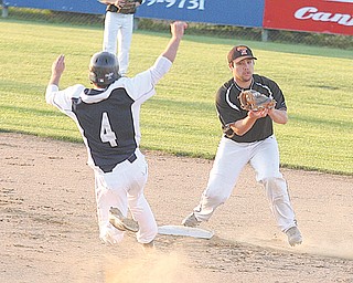 Cody Pitzo (10) of Springfield keeps his eye on Warren JFK baserunner Vince Infante (4) during their Division
IV district championship baseball game Wednesday at Cene Park in Struthers. Nick Russell tossed a
complete-game shutout, striking out seven batters, to lead the Tigers to a 10-0 win over the Eagles.