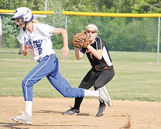 Poland’s Meredith Tesone (2) narrowly avoids being tagged out as Canfield shortstop Rachel Tinkey fields a line drive during the Division II district final softball game Wednesday at Alliance High School. Tinkey had
two hits for the Cardinals, who lost to the Bulldogs, 8-1. Poland starting pitcher Erin Gabriel, the reigning Ohio
Player of the Year, dominated the Cardinals with a complete game that included 15 strikeouts.