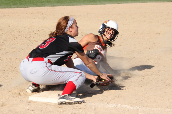 East Palestines Carly Blair (8,right) slides into third base underneath the tag by Girard's Alli Rose (13,left) during Thursdays district championship game at South Range High School in Canfield. Dustin Livesay  |  The Vindicator