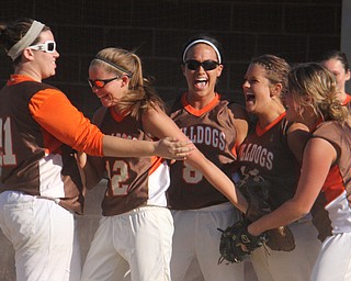 Members of the East Palestine softball team celebrate after getting the third out to beat Girard during Thursdays district championship game at South Range High School in Canfield. Dustin Livesay  |  The Vindicator