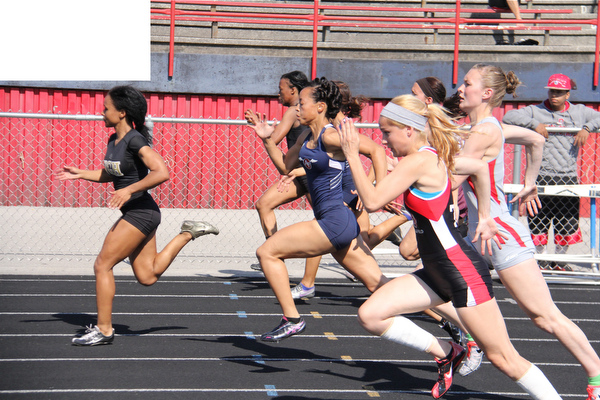 Junior Aminah Wesley of Warren G. Harding leads the pack during the half way mark of the 100 meter dash during Fridays Division one district championship track meet at Austintown Fitch High School.  Dustin Livesay  |  The Vindicator