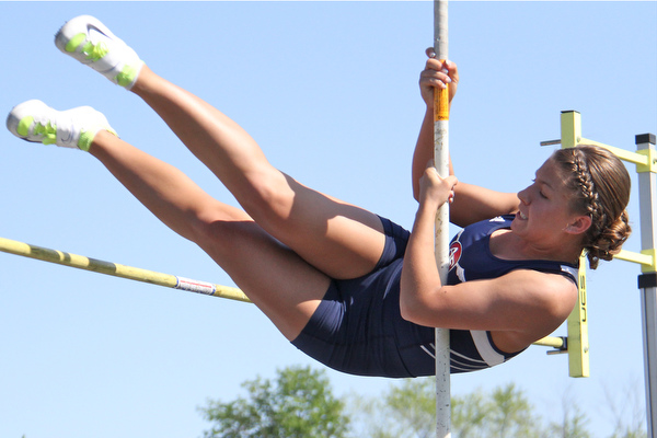 Junior Kayla Baily of Austintown Fitch kicks her legs up and over the pole vault pole during Fridays Division one district championship track meet at Austintown Fitch High School.  Dustin Livesay  |  The Vindicator