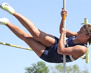 Junior Kayla Baily of Austintown Fitch kicks her legs up and over the pole vault pole during Fridays Division one district championship track meet at Austintown Fitch High School.  Dustin Livesay  |  The Vindicator