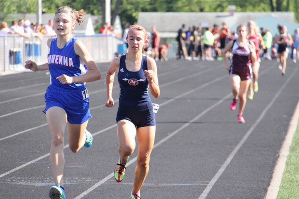 Olivia Chinn (left) of Ravenna runs neck and neck with Carissa Jenkins (right) of Austintown Fitch to the finish line of the 1600 meter run during Fridays Division one district championship track meet at Austintown Fitch High School.  Dustin Livesay  |  The Vindicator