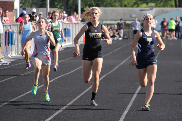 (L-R) Emily Deering of Geneva, Emily Stevens of Warren Harding, and Hallie Allen of Tallmadge match each other step by step across the finish line of the 400 meter run during Fridays Division one district championship track meet at Austintown Fitch High School.  Dustin Livesay  |  The Vindicator