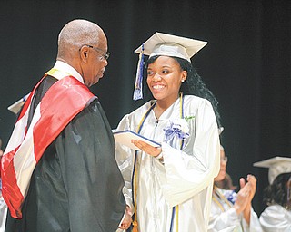 Graduate Kenisha Coleman, 17, receives her diploma from Youngstown Board of Education President Lock P. Beachum Sr. during the commencement ceremony for the 2012 graduating class of Youngstown Early College on Sunday in Powers Auditorium.