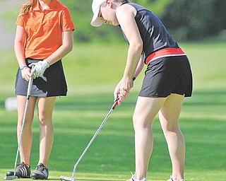 Caitlyn Butler, left, watches as Kerra Loomis lines up a putt during Sunday’s first-round qualifier in the Girls U-17 Division for The Greatest Junior Golfer of the Valley tournament at Pine Lakes Golf Club in Hubbard. The top two boys and girls in each division (U-17 and U-14) advanced to the championship final set for July 21 at Trumbull Country Club. Butler finished tied for third with a 91, and Loomis finished in fifth with a 96.