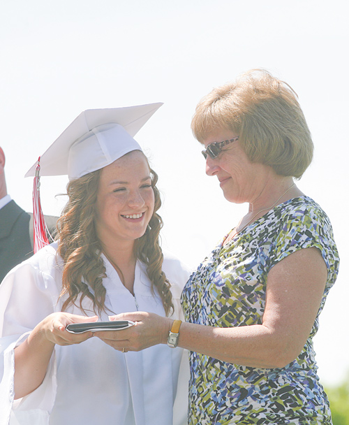 Graduate Sara Posey receives her diploma from her mother, Lori Posey, treasurer for the Columbiana Board of Education, during the commencement ceremony.