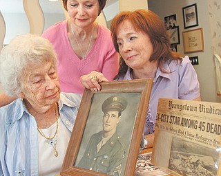 Rosemary McIntire, left, recalls memories of her first husband, Maurice Hamilton, who was killed in a plane bombing. Two of her daughters, Roseann Cencia, center, and Teresa Kondis, right, discuss their father and how their lives changed after his death. Hamilton and 44 others were killed May 22, 1962, when a bomb placed in the plane’s bathroom brought the aircraft down over the Iowa/Missouri line.