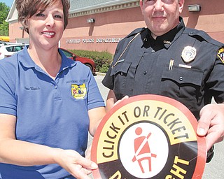Susan Viars, left, of Mahoning County Safe Communities and Scott Weamer, Canfield assistant police chief, discussed the kickoff of the national Click it or Ticket campaign. The campaign runs through June 3 and is designed to educate drivers about the dangers of not wearing a seat belt. Weamer said anyone pulled over
on a separate violation who is found to not be wearing a seat belt will be ticketed.