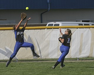 JESSICA M. KANALAS | THE VINDICATOR..Jackson Milton's #7 Shannon Ricketson jumps to catch an outfield fly but drops it due to her teammates close pressence during the top of the first inning against Mathews for the Division 3 Regional Semifinal game at Kent State University.