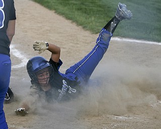 JESSICA M. KANALAS  | THE VINDICATOR..Jackson Milton's #7 Shannon Ricketson slides safely into home during the bottom of the third inning against Mathews for the Division 3 Regional Semifinal game at Kent State University.
