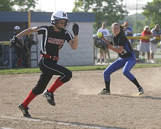 JESSICA M. KANALAS | THE VINDICATOR..Jackson Milton's #12 Paije Kiraly grounds a bunt in the top of the fifth inning as Mathews #7 Maddie Williams heads for first base during the Division 3 Regional Semifinal game at Kent State University.