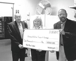 The Liberty Walmart store recently presented a $1,000 Walmart Foundation Grant check to Ebony Lifeline Support Group Inc. Pictured are Bob Thomas of Ebony, left; Philomena Serena, assistant manager of Walmart in Liberty; and William Allen of Ebony. The group, which assists individuals and family members in the transition from addiction to recovery, has served Mahoning and Trumbull counties since 1988.
