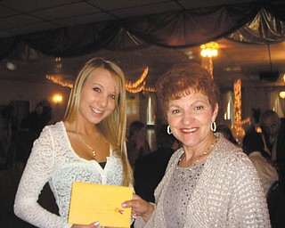Roselyn Gadd, right, of Girard Junior Women, presents a scholarship to Sahara Stauffer of Girard High School. The organization is dedicated to raising money for the Girard community, and student scholarships are a priority on the project list. The group also recently donated to the Emmanuel Center and has plans to plant flowers in downtown Girard. New members are welcome. For information visit the Girard Junior Women Facebook page.