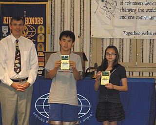 Alan Harper, president of the Kiwanis Club of Youngstown, presents Max Lee, winner of The Vindicator Regional Spelling Bee, and Tamsin Day, runner-up, with gift certificates to Barnes & Noble. The students were honored at the club’s weekly luncheon meeting in honor of their spelling achievements. Max is a seventh-grader at Canfield Middle School, and Tamsin is in seventh grade at Willow Creek Leaning Center.