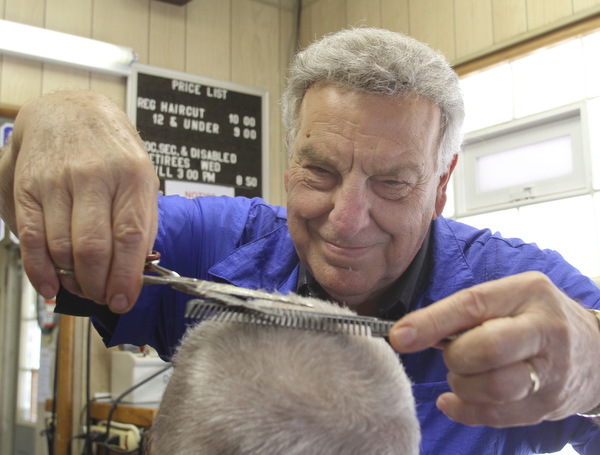 William D Lewis The Vindicator    Long time Youngstown barber Cosmo Pecchia gives a trim to Tom Shimet of Girard. Pecchia opened the shopin 1962 in the house on Oak St where he grew up.