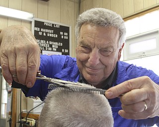 William D Lewis The Vindicator    Long time Youngstown barber Cosmo Pecchia gives a trim to Tom Shimet of Girard. Pecchia opened the shopin 1962 in the house on Oak St where he grew up.