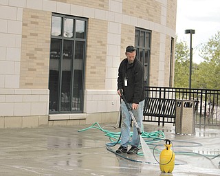 A worker sprays down the exterior walkway at the Nathaniel R. Jones Federal Building and U.S. Courthouse on Wick Avenue in downtown Youngstown. Exterior repairs to the structure are expected to be finished later this spring.