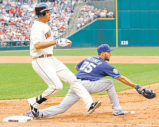 Cleveland Indians’ Juan Diaz reaches first base on an error by Kansas City Royals first baseman Eric Hosmer (35) in the seventh inning of Monday’s baseball game in Cleveland. The Indians held off the Royals to win 8-5.